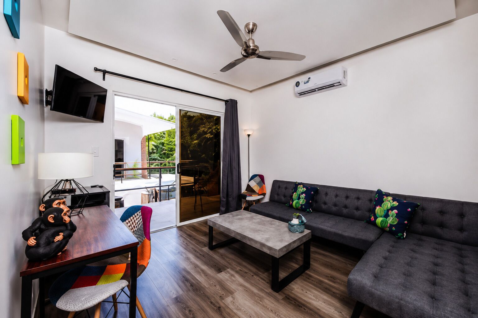 A modern living room with a sofa, coffee table, and a dining area with chairs.