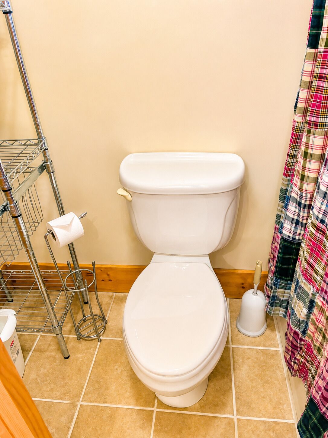 A toilet with a toilet paper holder and a bidet.