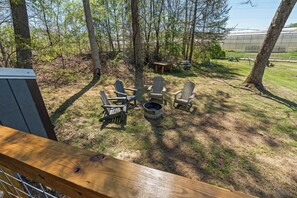 A deck with a fire pit and Adirondack chairs. - NEW 2 bed tiny home on the farm (Asheville)