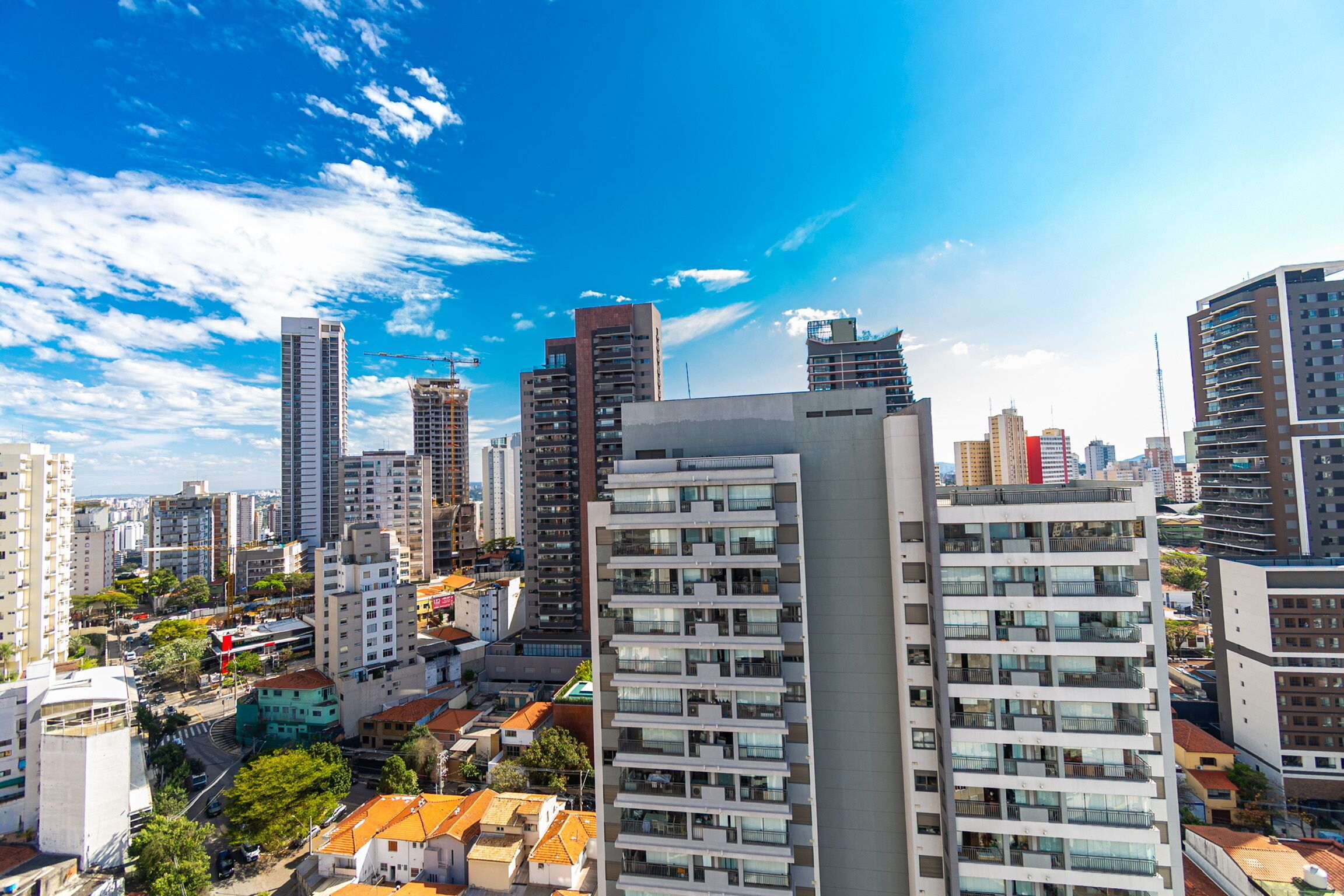A high-rise building with multiple balconies and a modern architectural design.
