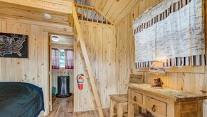 A wooden cabin interior with a staircase, a map on the wall, a desk, and a fire extinguisher. - Our Cabin is great for youth groups, reunions and families! (Buena Vista)