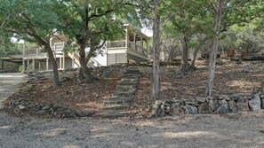 A building with a stone staircase and trees in the foreground. - River Access +EV + WI-FI+ Pets+ King+ Firepit (Hunt)
