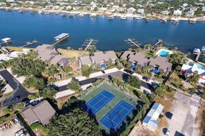 A residential area with houses, a marina, and a tennis court. - Needle Rush Point E34, Beach Access, 2 Pools, Riverfront, Private Beach (Pensacola)
