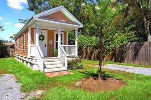 A small, single-story house with a porch, a front door, and a mailbox.