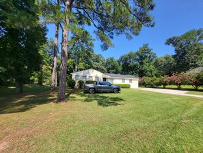 A residential property with a two-story house, a driveway, and a parked truck.