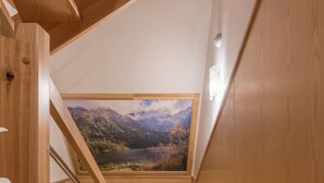 A wooden staircase leading to a loft bedroom with a large window overlooking a mountainous landscape. - Fantastic 9-bedroom house in Zakopane for your perfect getaway (Zakopane)