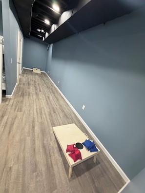 A room with a wooden floor, a table with a cushion, and a blue wall. - Cute and Convenient Cabin located close to Dale Hollow Lake-Cabin#4 (Burkesville)