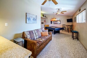 A room with a sofa, a pool table, a ceiling fan, and a television. - Sleeps 12 w/ ping pong & pool table| comfort + (Lake Havasu City)