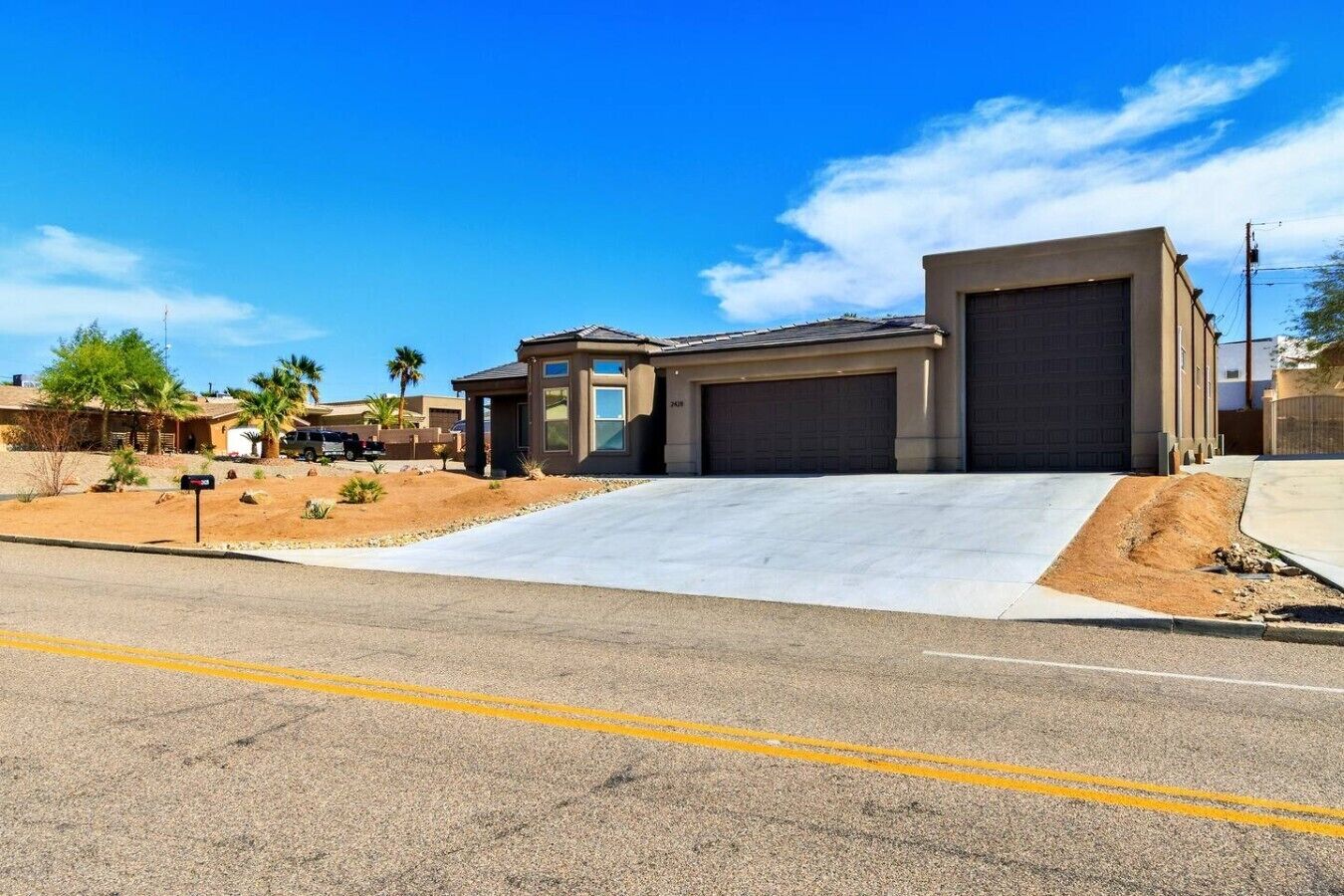 A residential property with a garage, a driveway, and a landscaped yard.