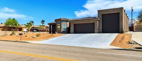 A residential property with a garage, a driveway, and a landscaped yard.
