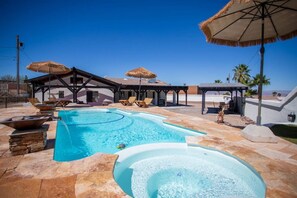 A swimming pool with a hot tub, lounge chairs, and umbrellas. - Pool, Spa, Table games, Multi boat parking, For 10 (Lake Havasu City)