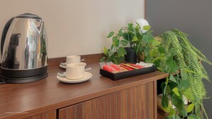 A wooden counter with a coffee maker, cups, and a tray of biscuits. - Flatsharing Design Studio - Moka (Milan)