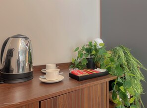 A wooden counter with a coffee maker, cups, and a tray of biscuits. - Flatsharing Design Studio - Moka (Milan)