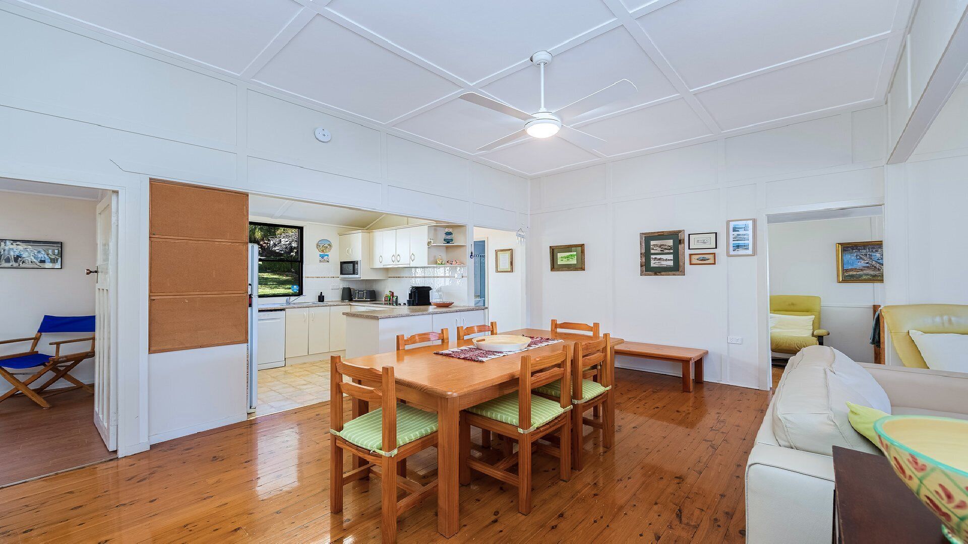 A compact living space with a dining area, kitchen, and seating area.
