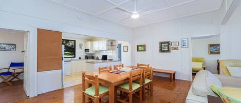 A compact living space with a dining area, kitchen, and seating area.