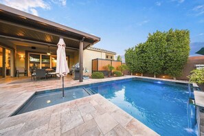 A swimming pool with a patio area, outdoor furniture, and a covered seating area. - Modern 5BR Pool Home Sleeps 15 Walk to Stadium (Glendale)