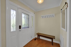 A hallway with a bench, a door with glass panels, and a coat rack with hooks. - Private Blue Ridge 3BR Haven, Luxury Hot Tub (Bakersville)