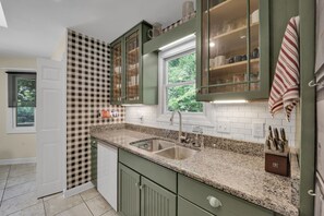 A kitchen with granite countertops, a double sink, and green cabinetry. - Private Blue Ridge 3BR Haven, Luxury Hot Tub (Bakersville)
