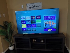 A television displaying a streaming service interface with various options like Netflix, Hulu, and Disney+. - Welcoming 4BR Luxury house with private POOL in charming Forney (Forney)