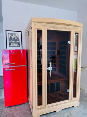 A red refrigerator and a wooden cabinet with glass doors. - HoT TuB PooL Sauna 5 BeD Pet Friendly Mansion (Murrells Inlet)