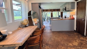 A kitchen with a central island, wooden furniture, and a view of the outdoors. - Blissful Marsh Front GuestHouse Getaway! (Charleston)