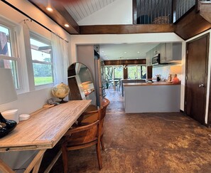 A kitchen with a central island, wooden furniture, and a view of the outdoors. - Blissful Marsh Front GuestHouse Getaway! (Charleston)