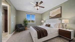 A bedroom with a bed, bedside tables, a ceiling fan, a window, and a view of the outdoors. - Wine Country Estate w/ Pool, Spa, Theater & Golf (Temecula)