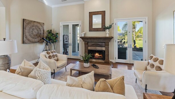 A living room with a fireplace, sofas, and a coffee table. - Wine Country Estate w/ Pool, Spa, Theater & Golf (Temecula)