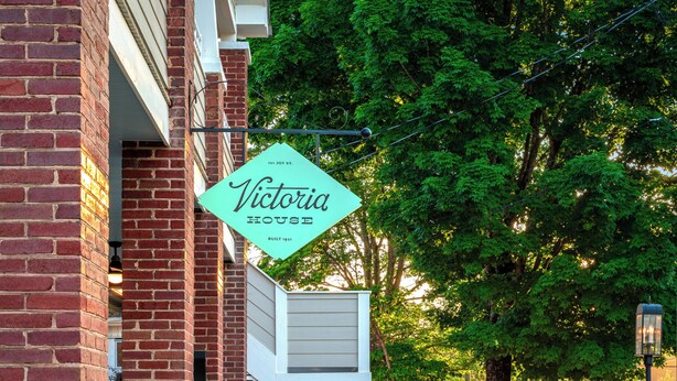 A brick building with a sign reading 'Victoria House.' - 2BR/2BA Hot Tub Suite • Coat of Many Colors (Sevierville)