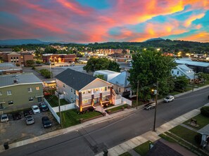 A town with buildings, roads, and a sunset sky. - 1BR Hot Tub Suite • Tennessee (Sevierville)