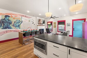 Eine moderne Küche mit schwarzer Arbeitsplatte, weißen Schränken und einem eingebauten Backofen.