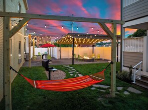 A backyard with a hammock, a barbecue grill, and string lights. - 2BR/2BA Hot Tub Suite • Songbirds (Sevierville)