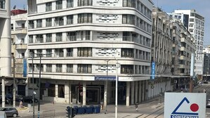 A multi-story building with a sign for 'HOTEL DELTA ATLAS' and a tram track running in front. - Spacious 2-Bedroom Apartment in Central Casablanca – Sleeps 5 (Casablanca)