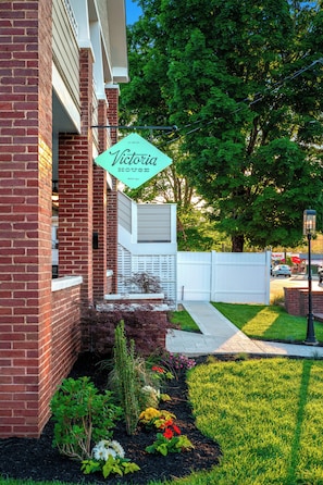 A brick building with a sign reading 'Victoria House.' - 1BR Hot Tub Suite • Butterfly (Sevierville)