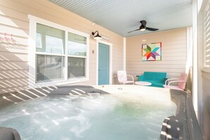 A hot tub area with a ceiling fan, a door labeled '5', and a colorful geometric wall art piece. - 1BR Hot Tub Suite • Butterfly (Sevierville)