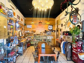 A diner with a central table, various signs, and memorabilia on the walls. - Modern Tifton Getaway - 3BR + Pool Access (Tifton)