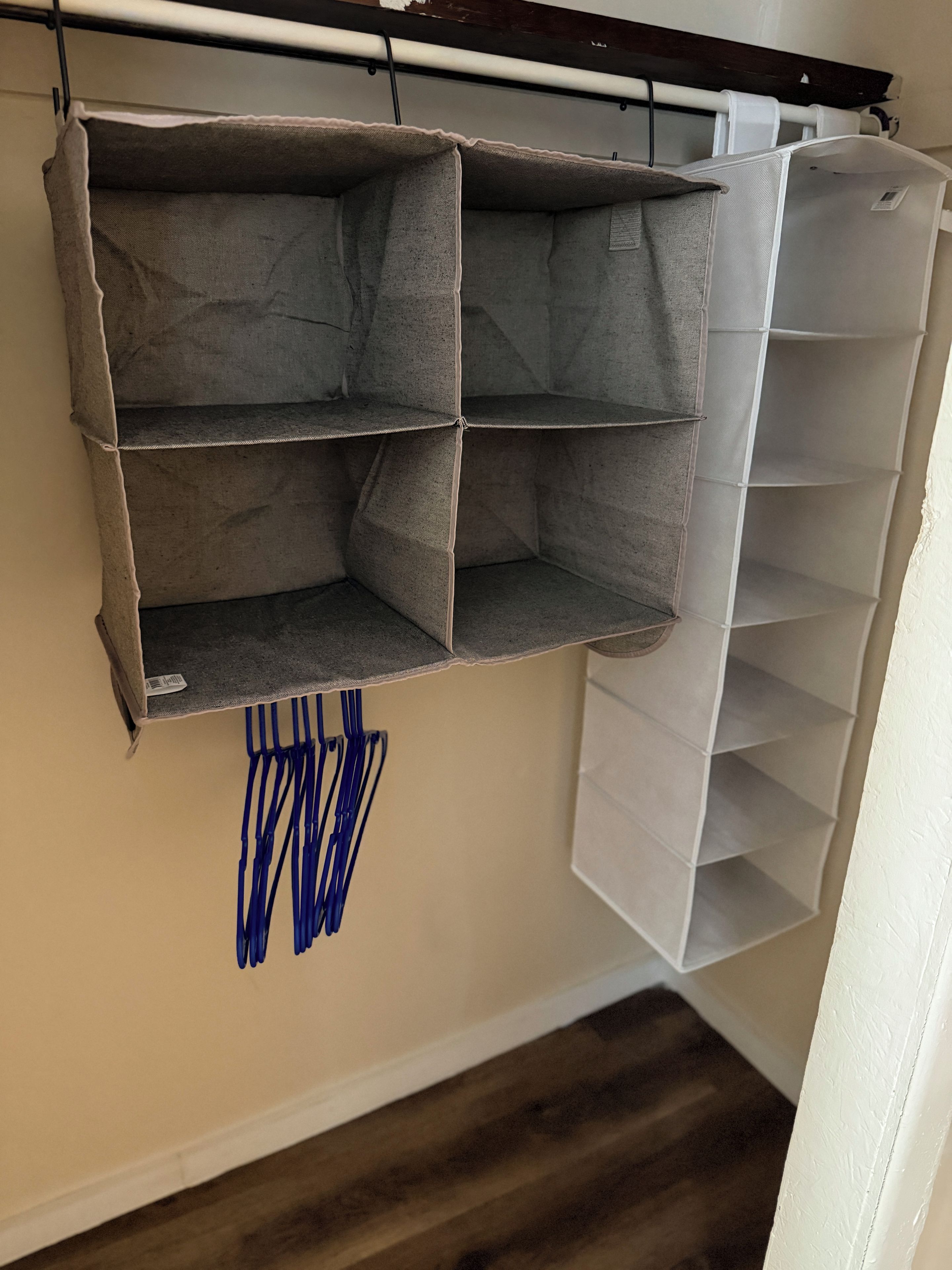 A storage unit with multiple compartments and a hanging blue item.