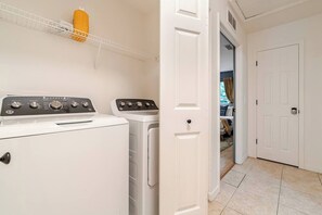 A laundry area with two washing machines and a drying rack. - The Designer Boutique • 3BR/2BA by UF • Firepit (Gainesville)
