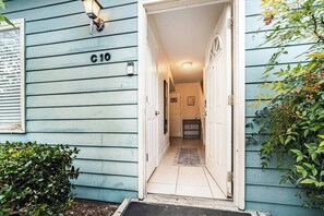 A hallway leading to a room with a door marked 'C10'. - Spacious 4BR | Near UF & Shands | Pool + Gym (Gainesville)
