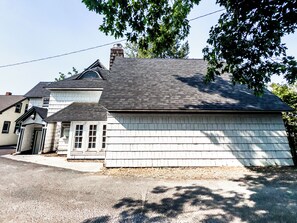 A two-story house with a chimney, a garage, and a driveway.