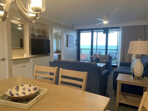 A hotel room with a dining area, a living room with a view, and a balcony with a view of the sea. - 2-bedroom apt BEACHFRONT on Marco Island - Eagle's Nest Resort PRESIDENT'S WEEK! (Marco Island)