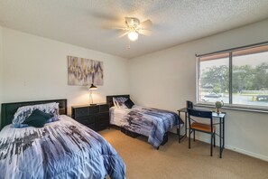 A bedroom with two beds, a desk, a globe, and a ceiling fan. - Townhome w/ Private Patio, 2 Mi to Dtwn Lakeland (Lakeland)