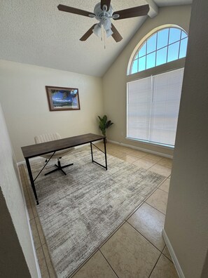 A room with a ceiling fan, a desk, a chair, a window with blinds, and a framed picture on the wall. - Paradise Cove! Peaceful 3bedroom plus office home in friendly safe neighborhood! (Copperas Cove)