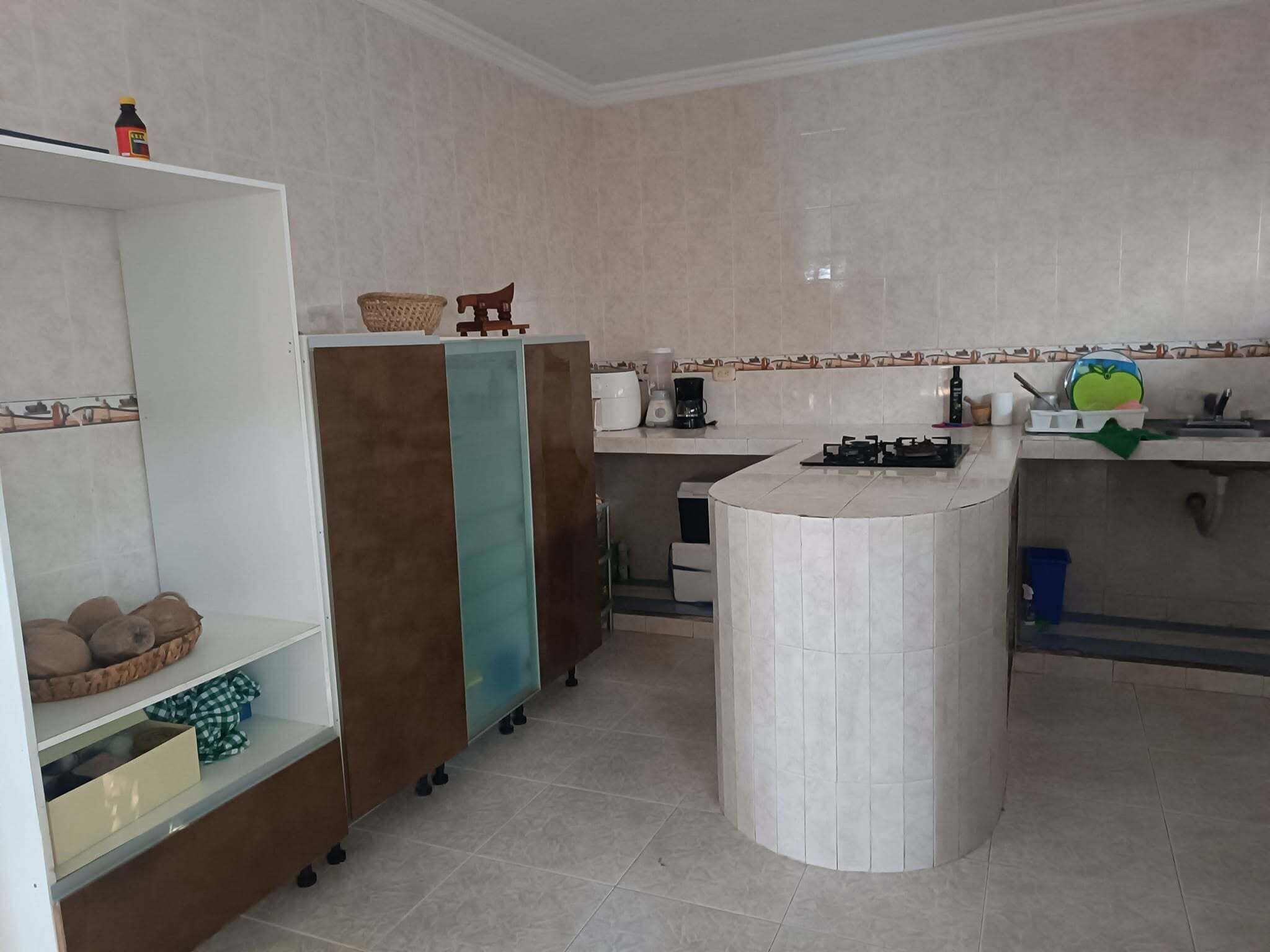 A kitchen with a central island, a sink, and various appliances.