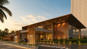 A modern building with a large entrance, a car parked in front, and a fountain. - #2 Apartment Vista Playground Beach GAV Resorts (Salinópolis)