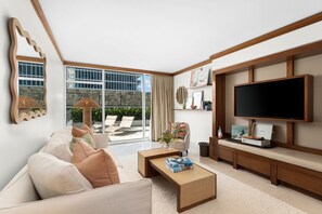 A modern living room with a sofa, coffee table, and a flat-screen TV.