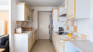 A compact kitchen with white cabinets, a toaster, a kettle, and a microwave. - **La Casa 67 – 2-Bedroom Apartment in Annecy City Center – Balcony** (Annecy)
