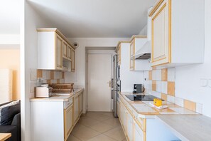 A compact kitchen with white cabinets, a toaster, a kettle, and a microwave. - **La Casa 67 – 2-Bedroom Apartment in Annecy City Center – Balcony** (Annecy)