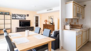 A compact living space with a dining area, a kitchenette, and a television. - **La Casa 67 – 2-Bedroom Apartment in Annecy City Center – Balcony** (Annecy)