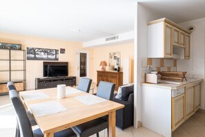 A compact living space with a dining area, a kitchenette, and a television. - **La Casa 67 – 2-Bedroom Apartment in Annecy City Center – Balcony** (Annecy)